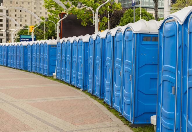 a row of portable restrooms set up for a large athletic event, allowing participants and spectators to easily take care of their needs in Montebello